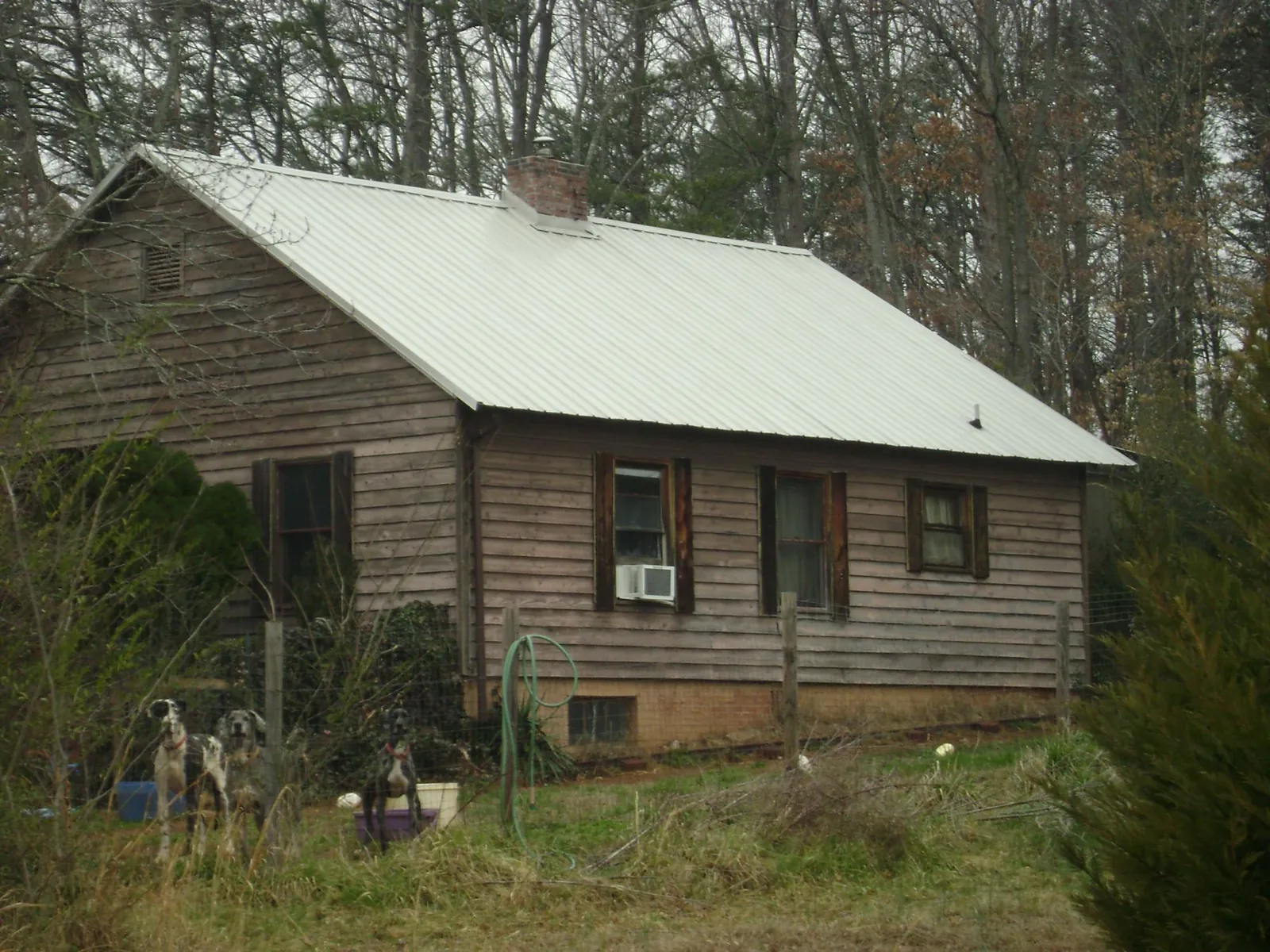 White metal roof on an old wood sided farmhouse, from a Metal Roof Installation job in Wauseon